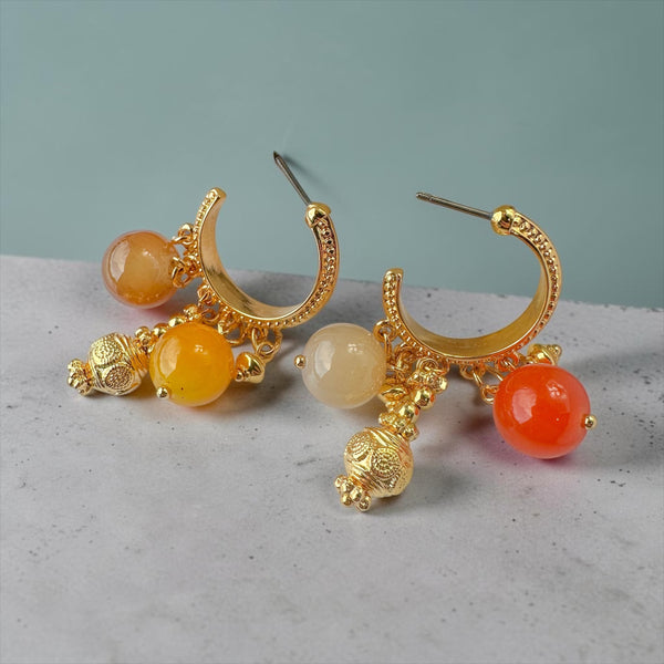 Χειροποίητα χρυσά σκουλαρίκια κρίκοι με γυάλινες χάντρες σε ζεστές αποχρώσεις