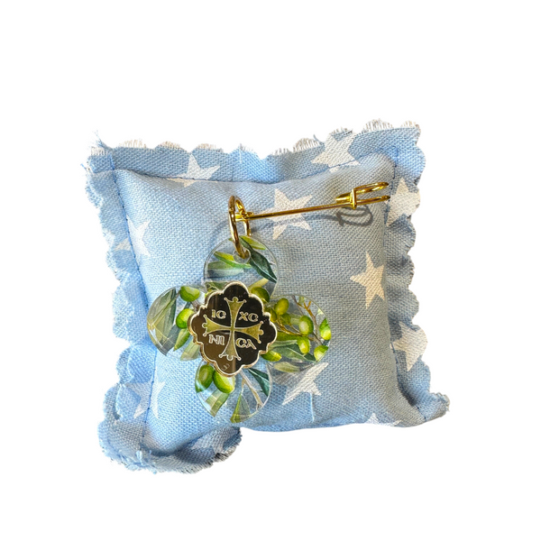 elephantina.gr baby pin featuring a cross charm with olive branch print and IC XC NI CA inscription on a star pillow