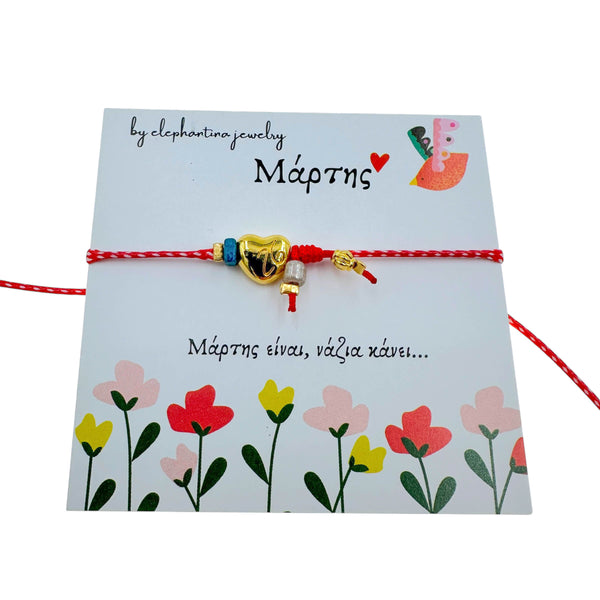 Μαρτάκι Βραχιόλι με Καρδιά & Μπλε Πέτρα – Χρυσά Στοιχεία σε Κόκκινη-Λευκή Κλωστή