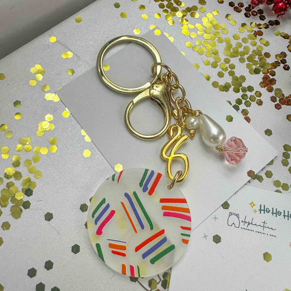 Μπρελόκ Γούρι 2026 Πλέξιγκλας – Πολύχρωμες Γραμμές