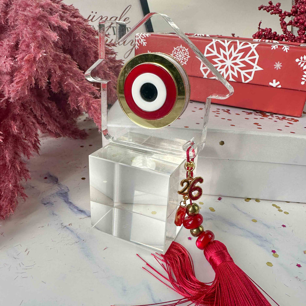 Γούρι 2026 – Plexiglass Σπίτι με Κόκκινο-Χρυσό Μάτι και Μεταξωτή Φούντα