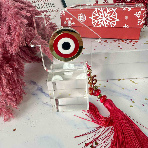 Γούρι 2026 – Plexiglass Σπίτι με Κόκκινο-Χρυσό Μάτι και Μεταξωτή Φούντα