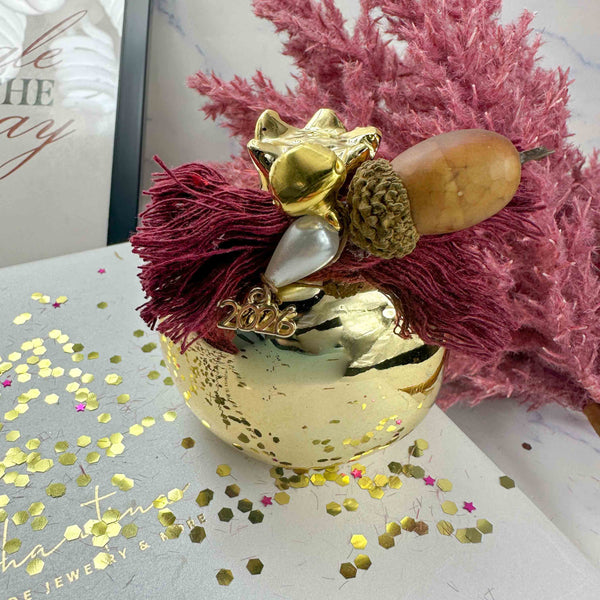 Κεραμικό Χρυσό Ρόδι Διακοσμητικό – Γούρι 2026 με Μπορντό Βαμβακερές Κλωστές (7×7cm)