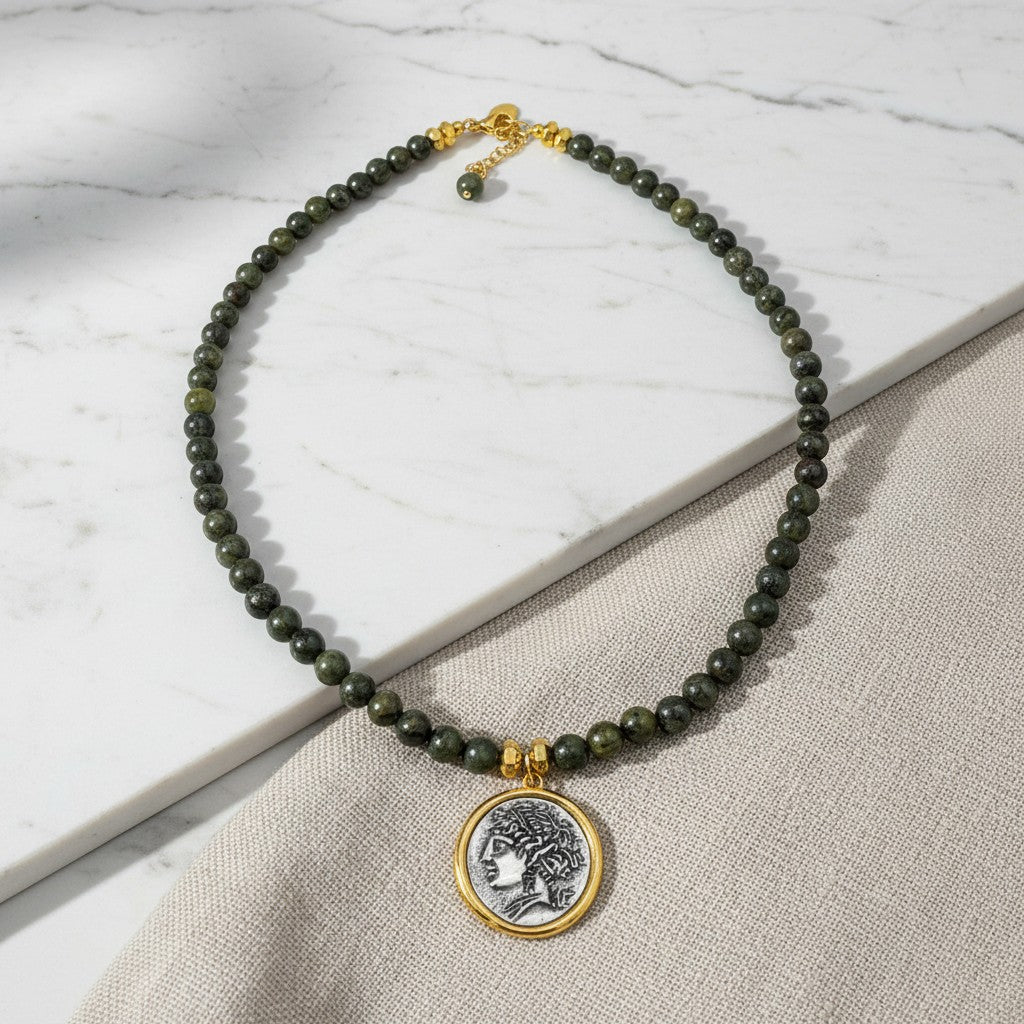 elephantina.gr Bahh necklace featuring dark green beaded stones and a gold-framed silver ancient coin pendant
