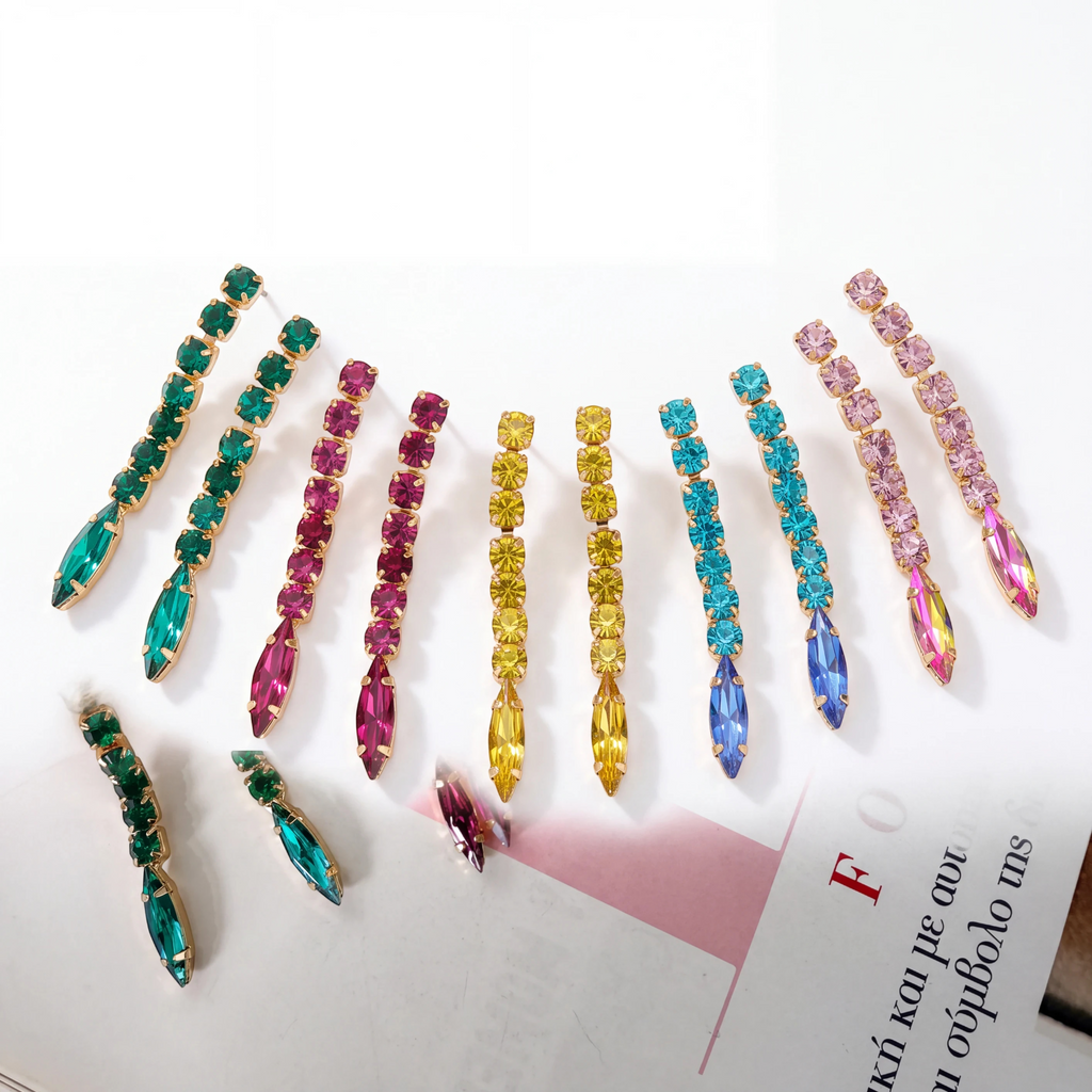 elephantina.gr long drop earrings featuring rows of colorful crystals in green, fuchsia, yellow, blue, and lilac.