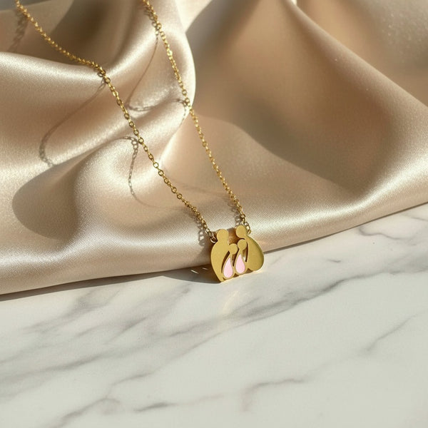 elephantina.gr gold-tone stainless steel family necklace featuring mom, dad, and two daughters with pink accents.