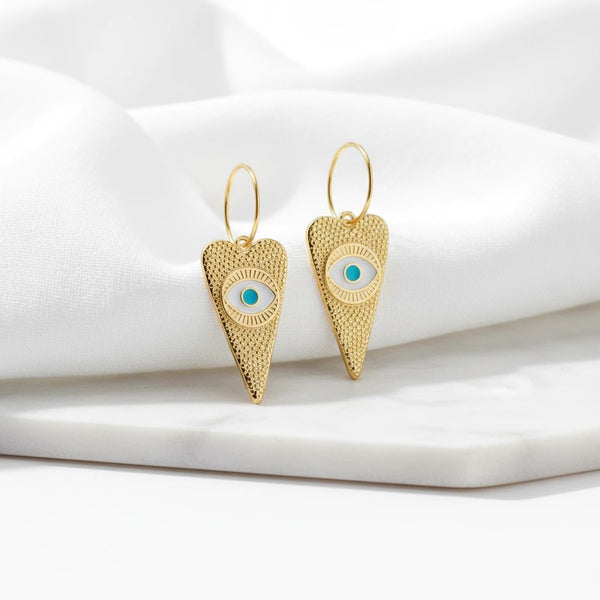 elephantina.gr 24K gold-plated brass hoop earrings featuring heart-shaped charms with a turquoise evil eye motif.