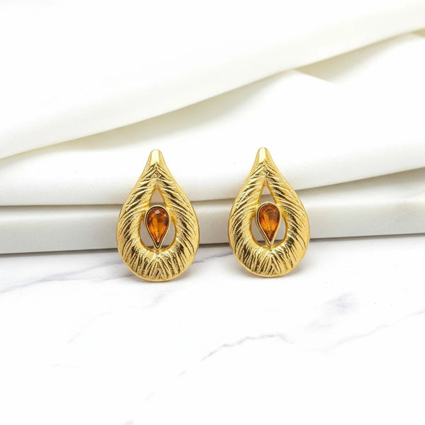elephantina.gr gold leaf-shaped brass earrings with textured finish and brown enamel teardrop detail.
