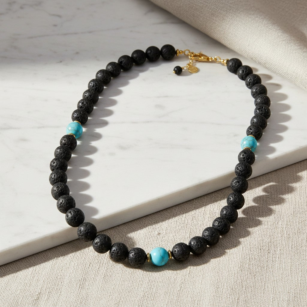 elephantina.gr beaded necklace featuring black lava stone beads and vibrant turquoise accents with gold-tone hardware