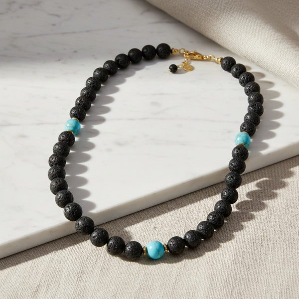 elephantina.gr beaded necklace featuring black lava stone beads and vibrant turquoise accents with gold-tone hardware