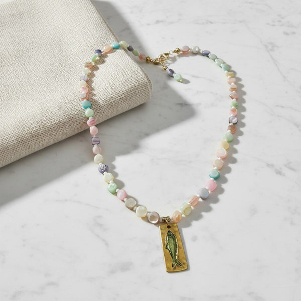 elephantina.gr necklace featuring pastel shell beads and a rectangular gold pendant with a green fish charm