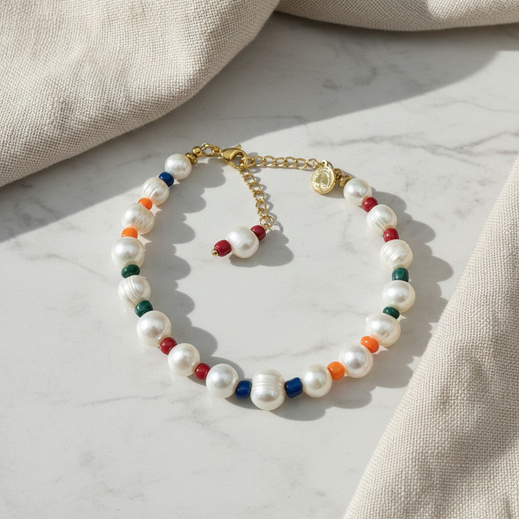 elephantina.gr pearl bracelet with colourful glass beads and gold-toned clasp on a marble surface