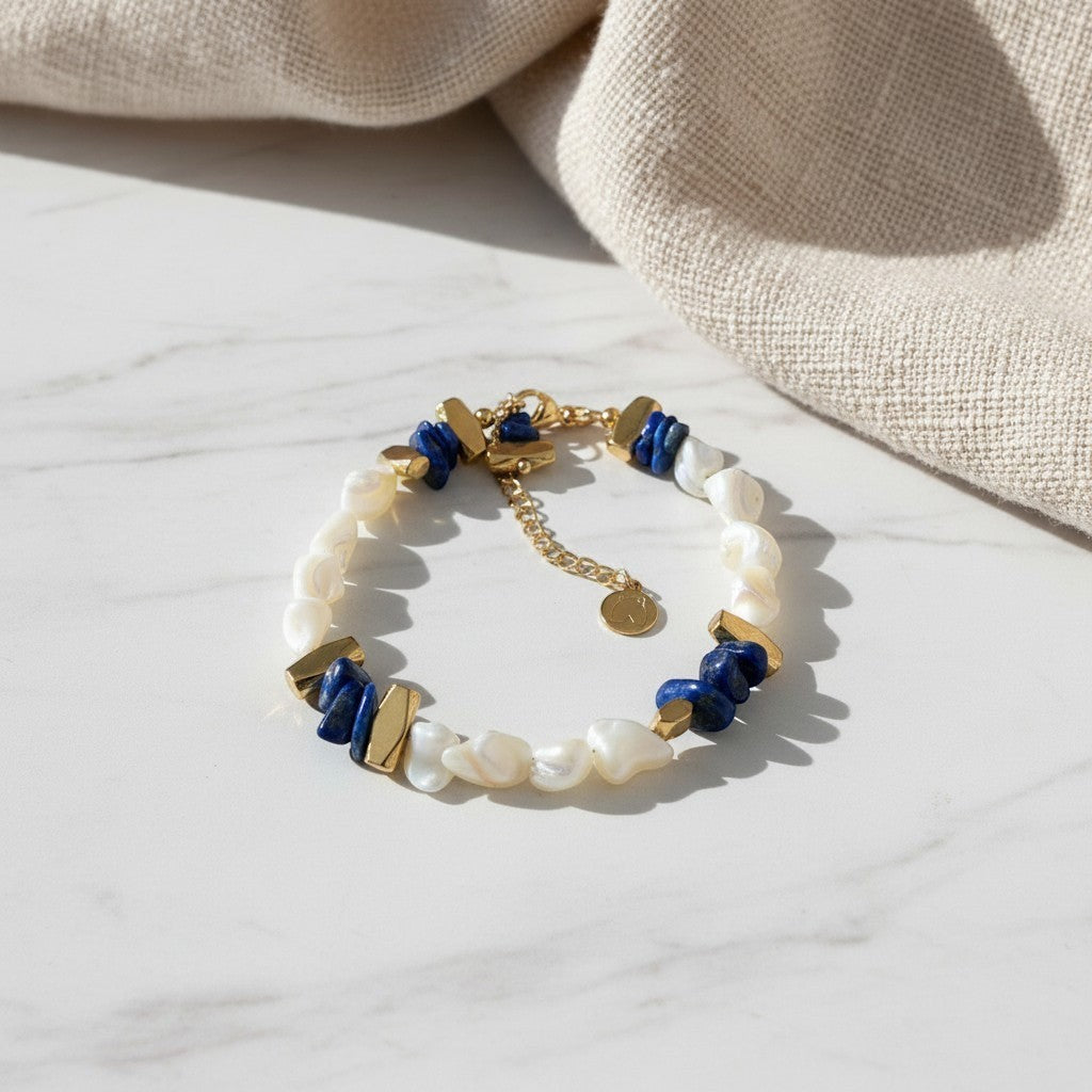 elephantina.gr Hhyuii bracelet featuring white baroque pearls, blue lapis lazuli stones, and gold-tone metal accents.