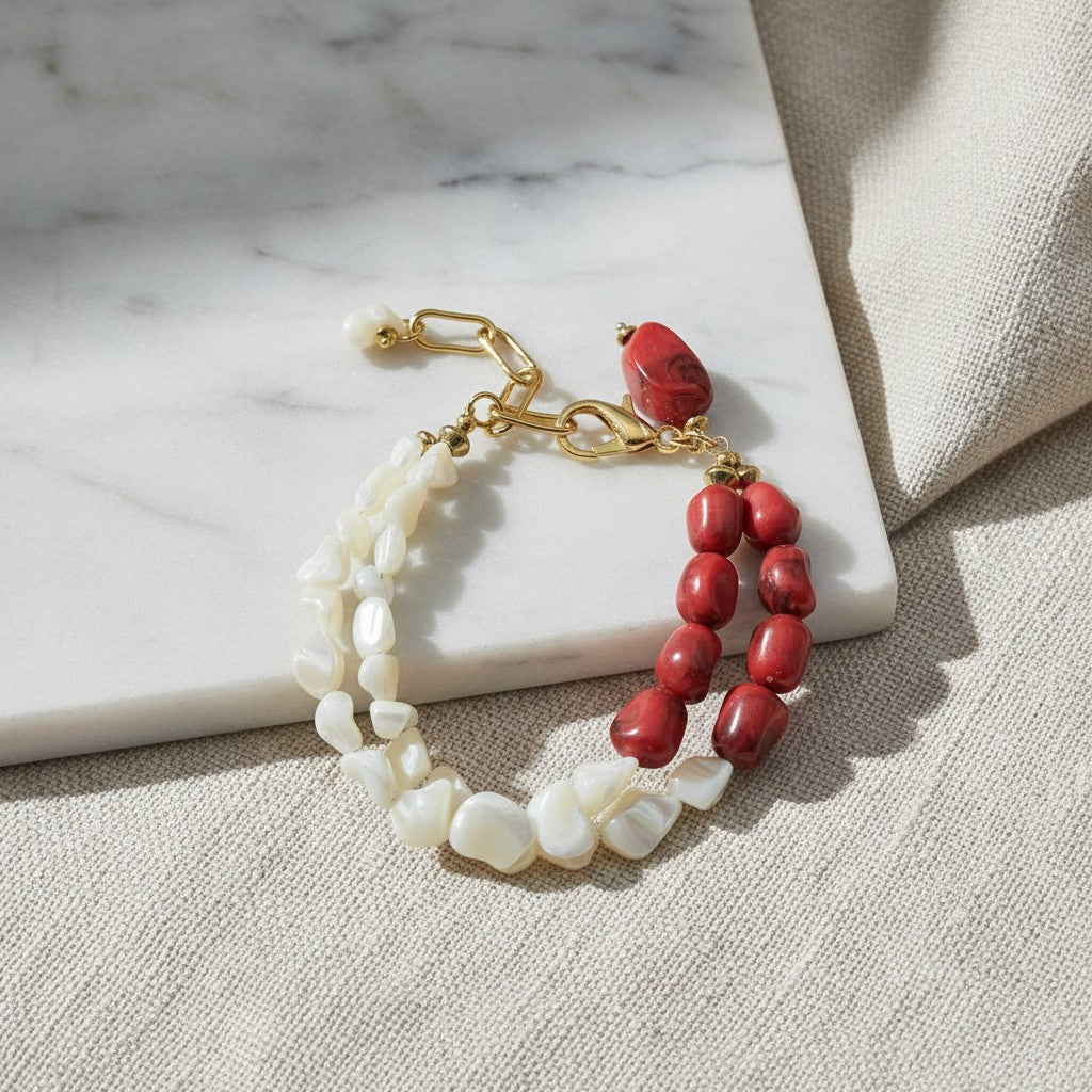 elephantina.gr double-strand bracelet featuring white shell chips and red coral beads with gold-tone metal hardware