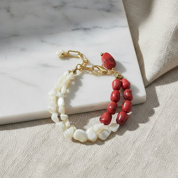 elephantina.gr double-strand bracelet featuring white shell chips and red coral beads with gold-tone metal hardware