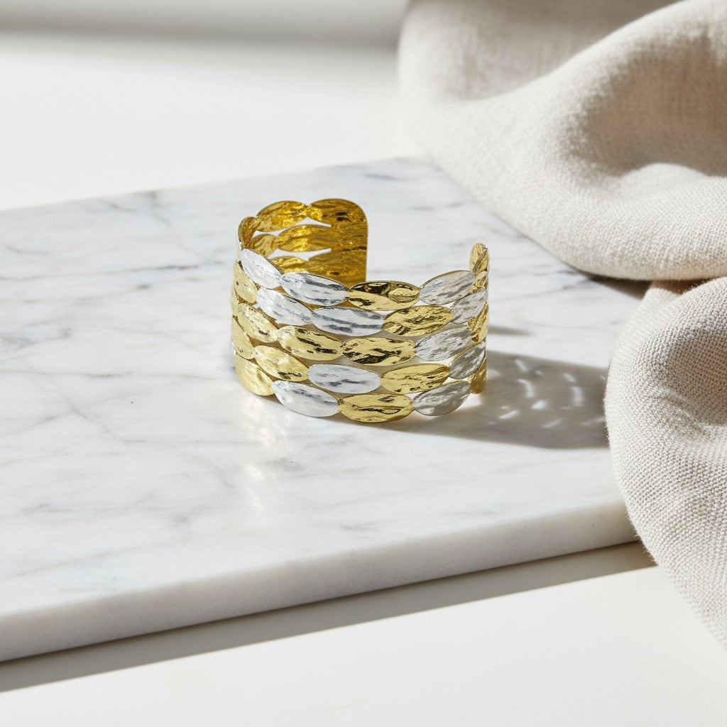 Χειροποίητο βραχιόλι cuff elephantina.gr σε χρυσό και ασημί χρώμα με σφυρήλατη υφή και σχέδιο από κρίκους.