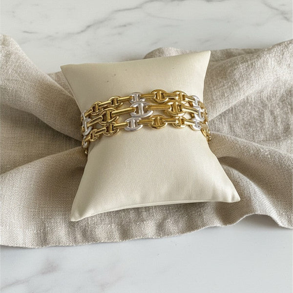 elephantina.gr two-tone gold and silver chain link bracelet displayed on a small cream cushion