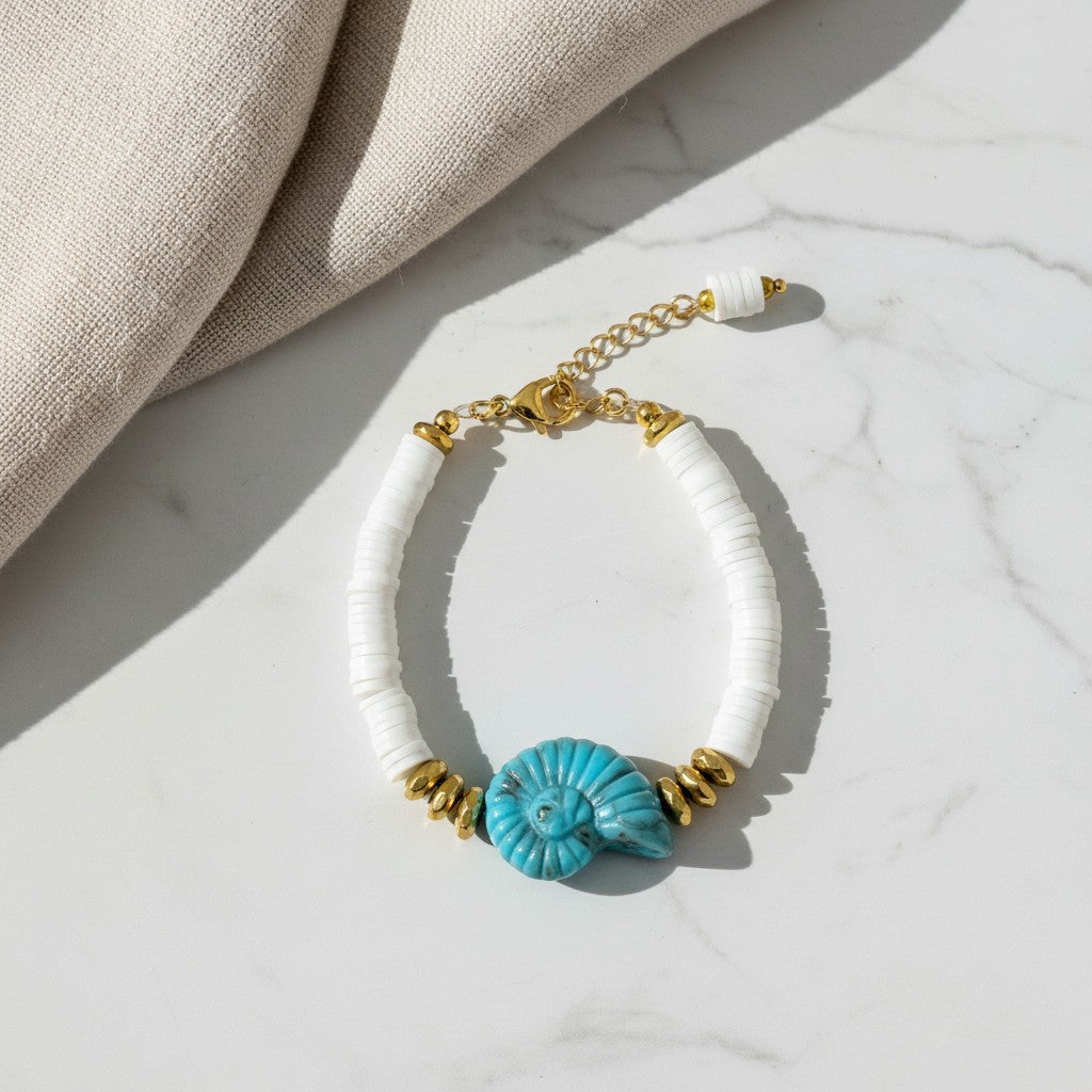 elephantina.gr bracelet featuring white heishi beads, gold accents, and a turquoise ammonite shell charm
