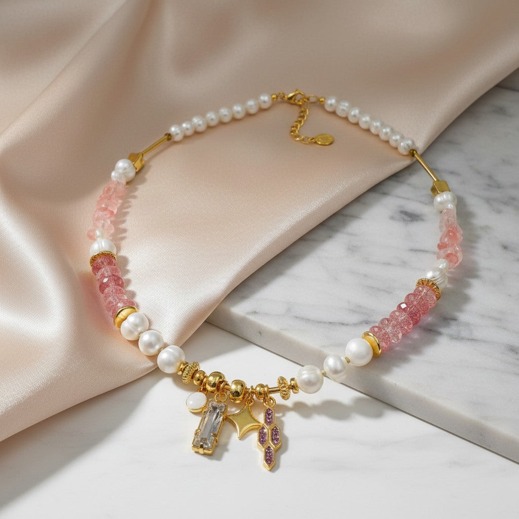 Elephantina.gr Celeste necklace with pearls, pink stones, gold charms including a baguette crystal, star, and glitter enamel. Adjustable.