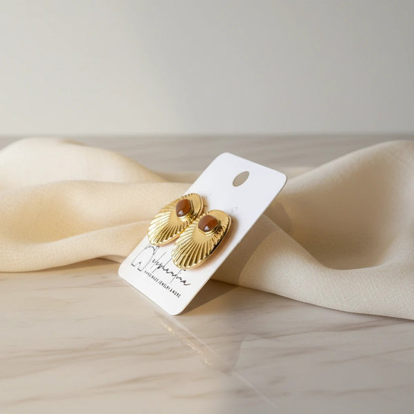 elephantina.gr gold-tone oval cabochon stud earrings with textured sunburst design and amber stone.