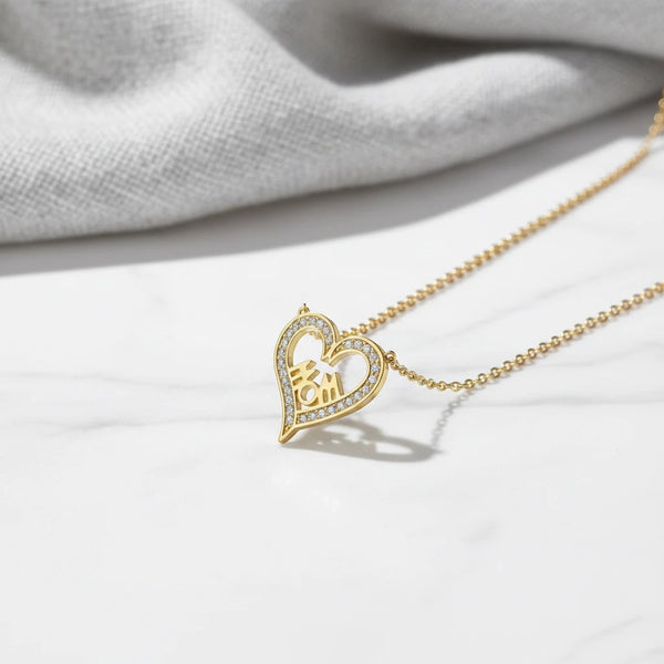 Gold heart necklace with "Mom" cutout, adorned with white zircons. Stainless steel chain. Perfect gift for mothers.