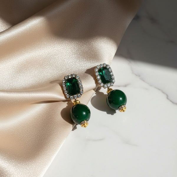 Elephantina.gr emerald-cut green gemstone drop earrings with crystal accents and a smooth green bead.