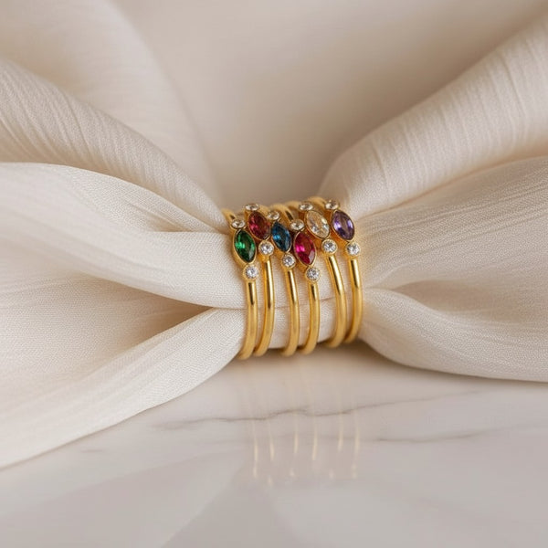 Stack of elephantina.gr gold-plated steel rings with colorful marquise-cut crystals and white zircons.