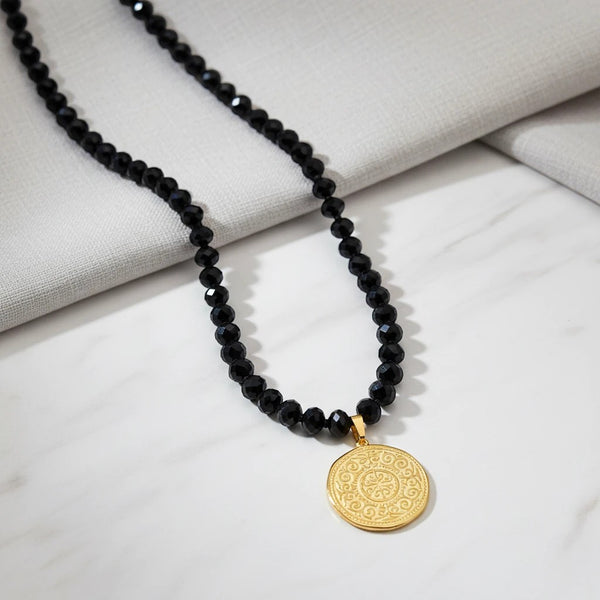 elephantina.gr black crystal beaded necklace with 24K gold-plated Arabic motif pendant. 45cm chain.