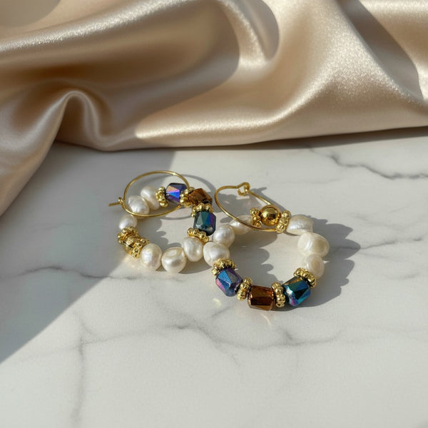 elephantina.gr handmade gold hoop earrings with cultured pearls and colorful iridescent crystals on marble surface