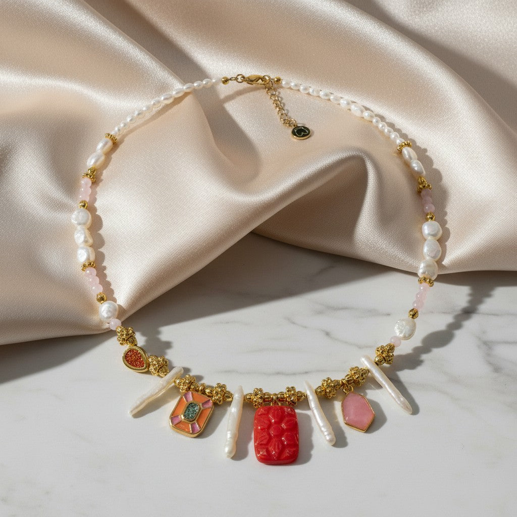 Elephantina.gr necklace with Biwa pearls, pink stones, and red & orange enamel in ancient Greek design. Gold accents.