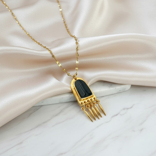 Elephantina.gr gold-tone stainless steel chain necklace with black enamel pendant and dangling spike charms.