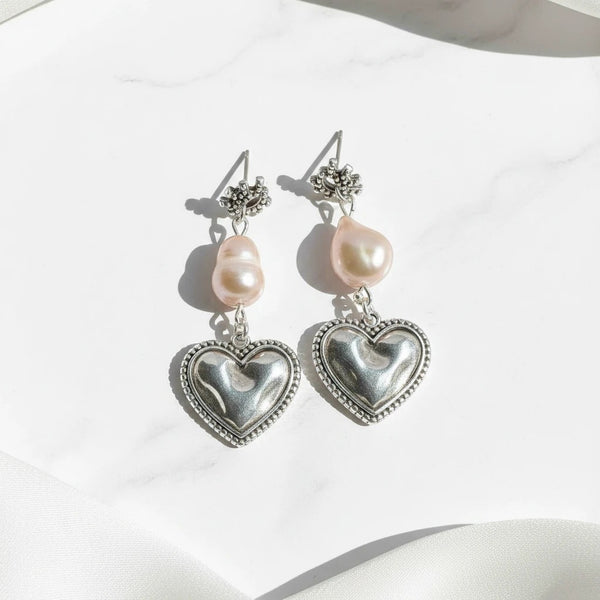 elephantina.gr silver-plated brass stud earrings with baroque pearls and heart charms featuring an evil eye design.