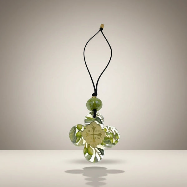 Clear acrylic cross ornament with olive branch design, gold emblem, and green bead. elephantina.gr