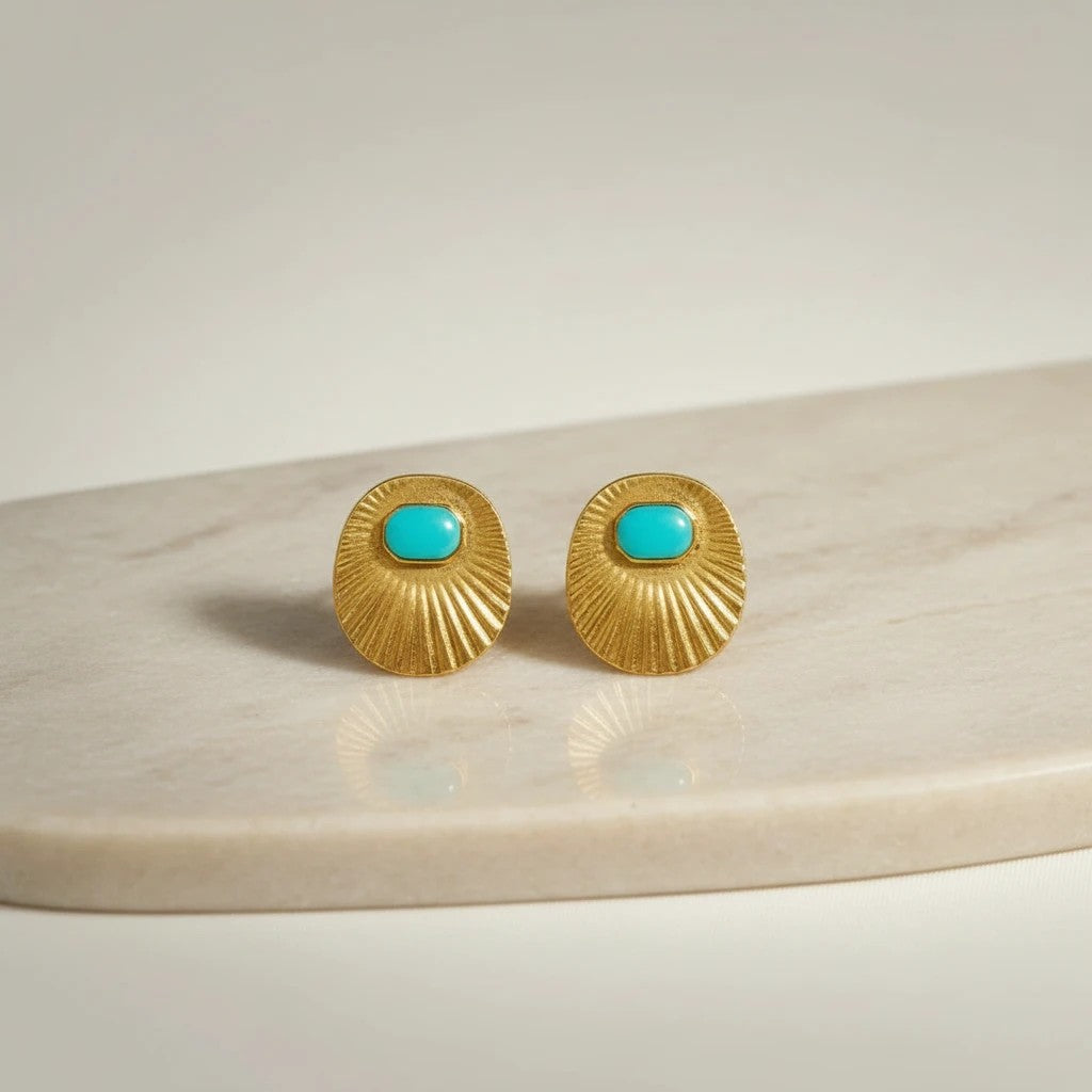 Gold oval stud earrings with turquoise inlay and sunburst texture, from elephantina.gr