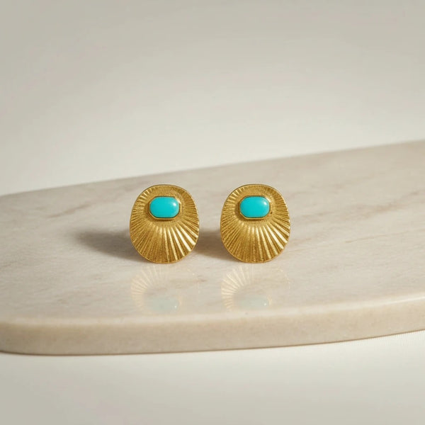 Gold oval stud earrings with turquoise inlay and sunburst texture, from elephantina.gr