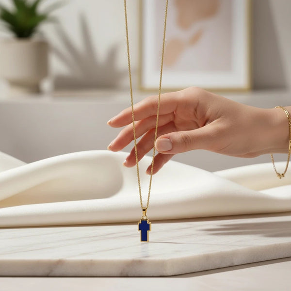 Gold-tone chain necklace with a blue cross pendant, a modern take on a classic symbol by elephantina.gr