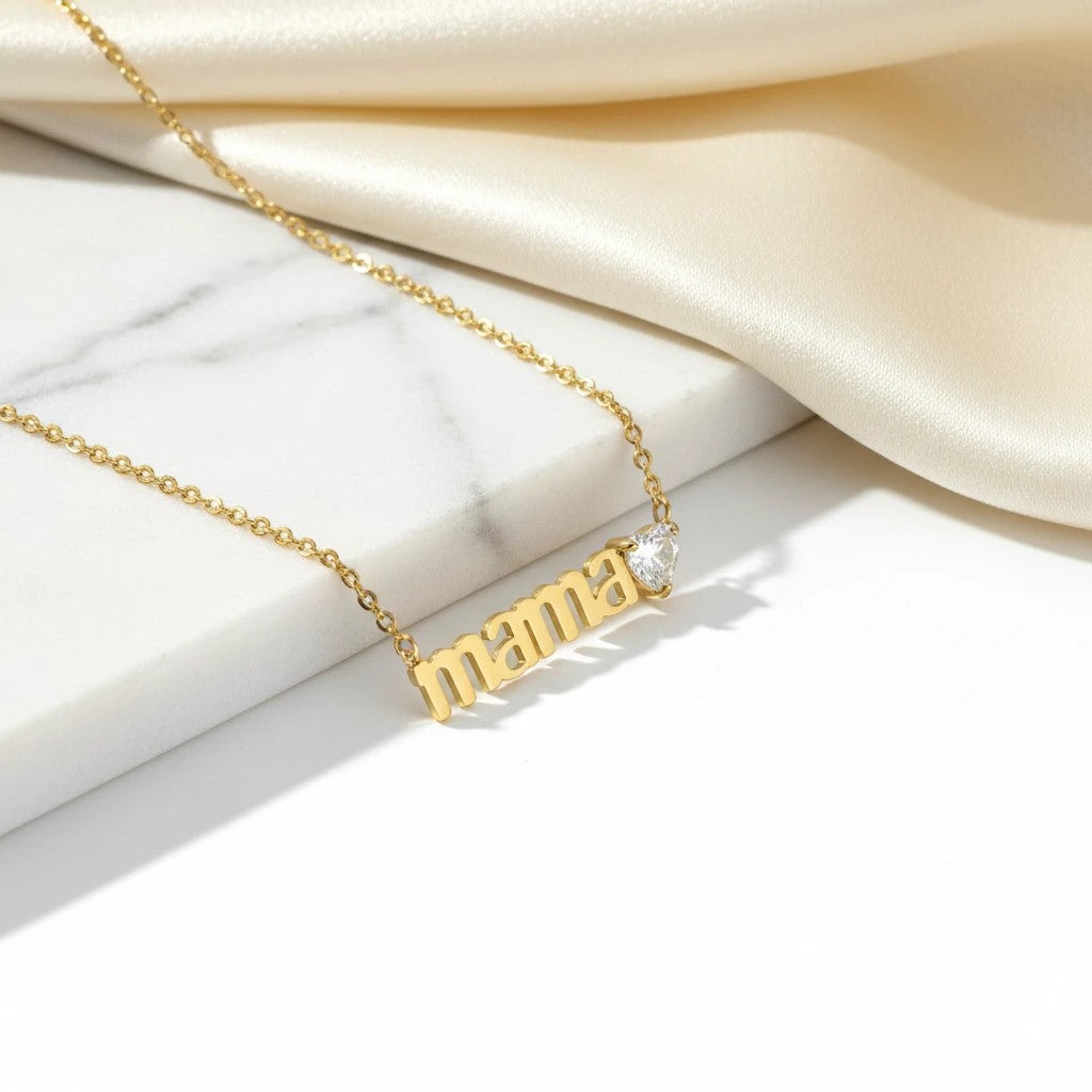 Gold tone stainless steel necklace with "Mama" text and a heart-shaped white zircon. A gift for mothers.
