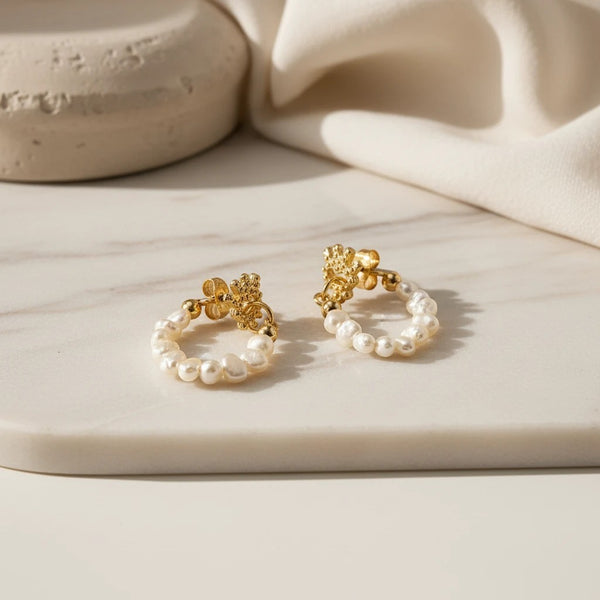 Elephantina.gr gold pearl hoop effect earrings with a small evil eye stud and natural pearls.