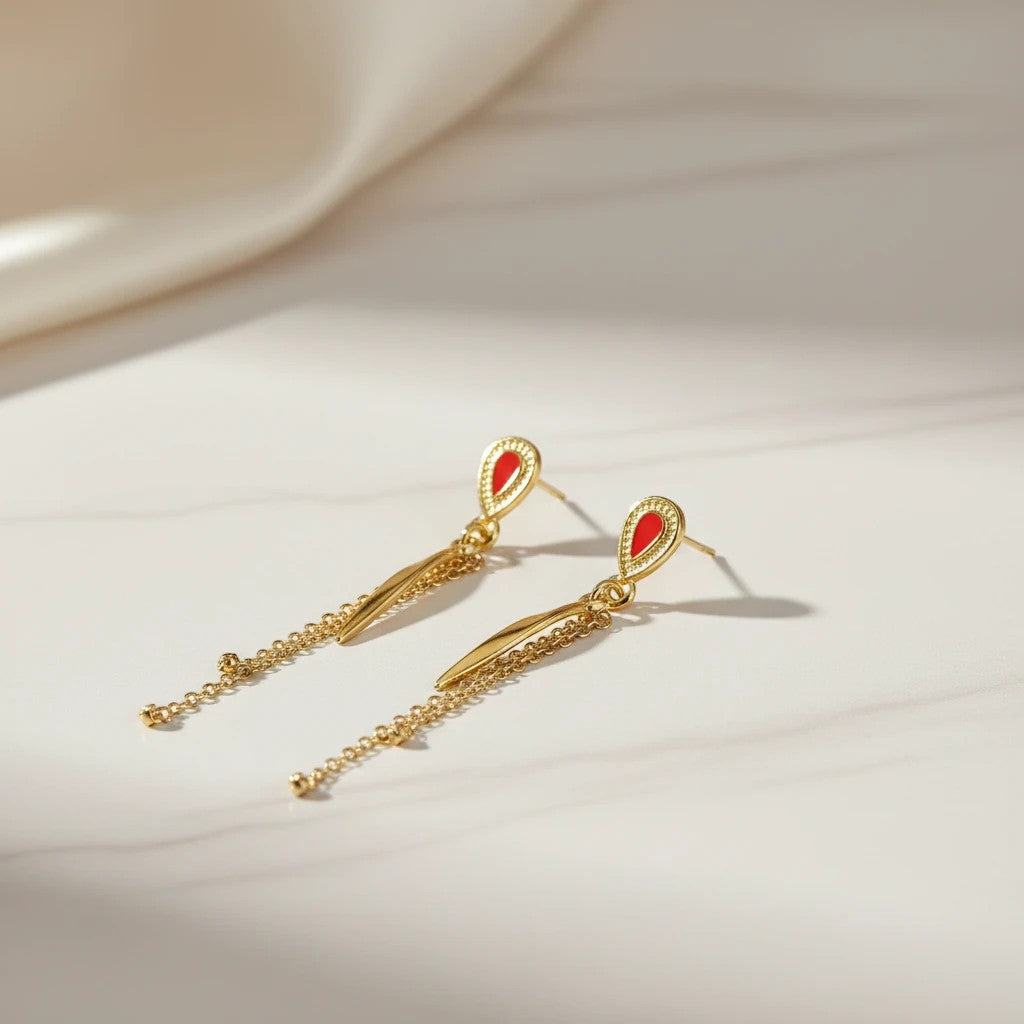 Gold teardrop dangle earrings with red enamel inlay and delicate chain tassels. elephantina.gr