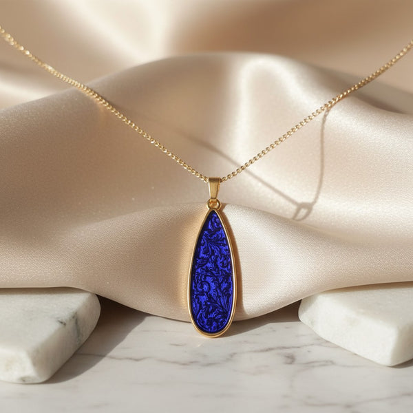 elephantina.gr teardrop pendant necklace with embossed purple-blue enamel and gold-plated chain.