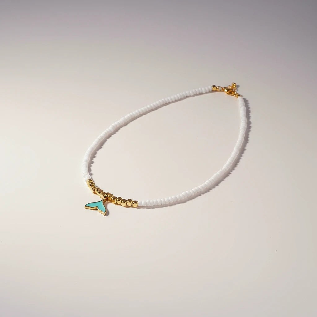elephantina.gr white beaded necklace with gold accents and turquoise whale tail charm, 40cm + 5cm extension