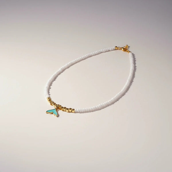 elephantina.gr white beaded necklace with gold accents and turquoise whale tail charm, 40cm + 5cm extension