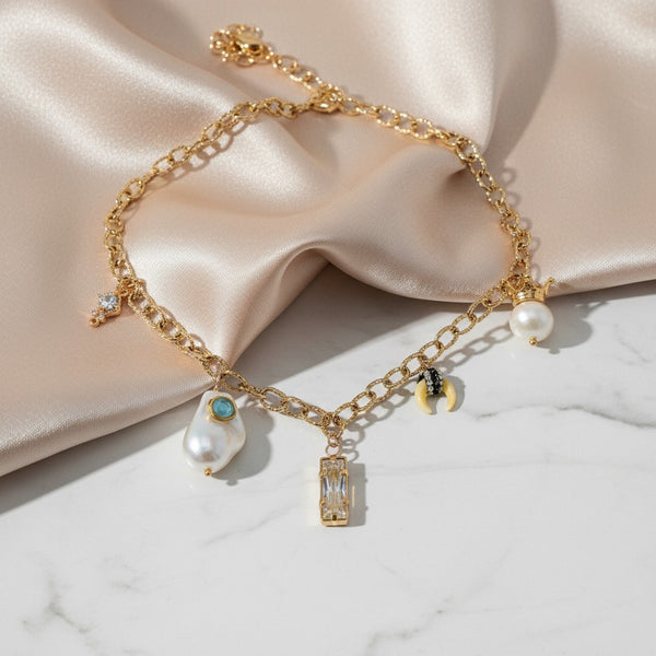 elephantina.gr gold chain necklace with baroque pearl, aquamarine, crystal, shell, and strawberry charms