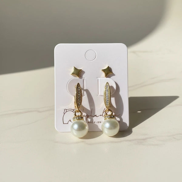 Elegant pearl drop earrings with star studs, gold-tone hoops with cubic zirconia, and creamy pearls. elephantina.gr