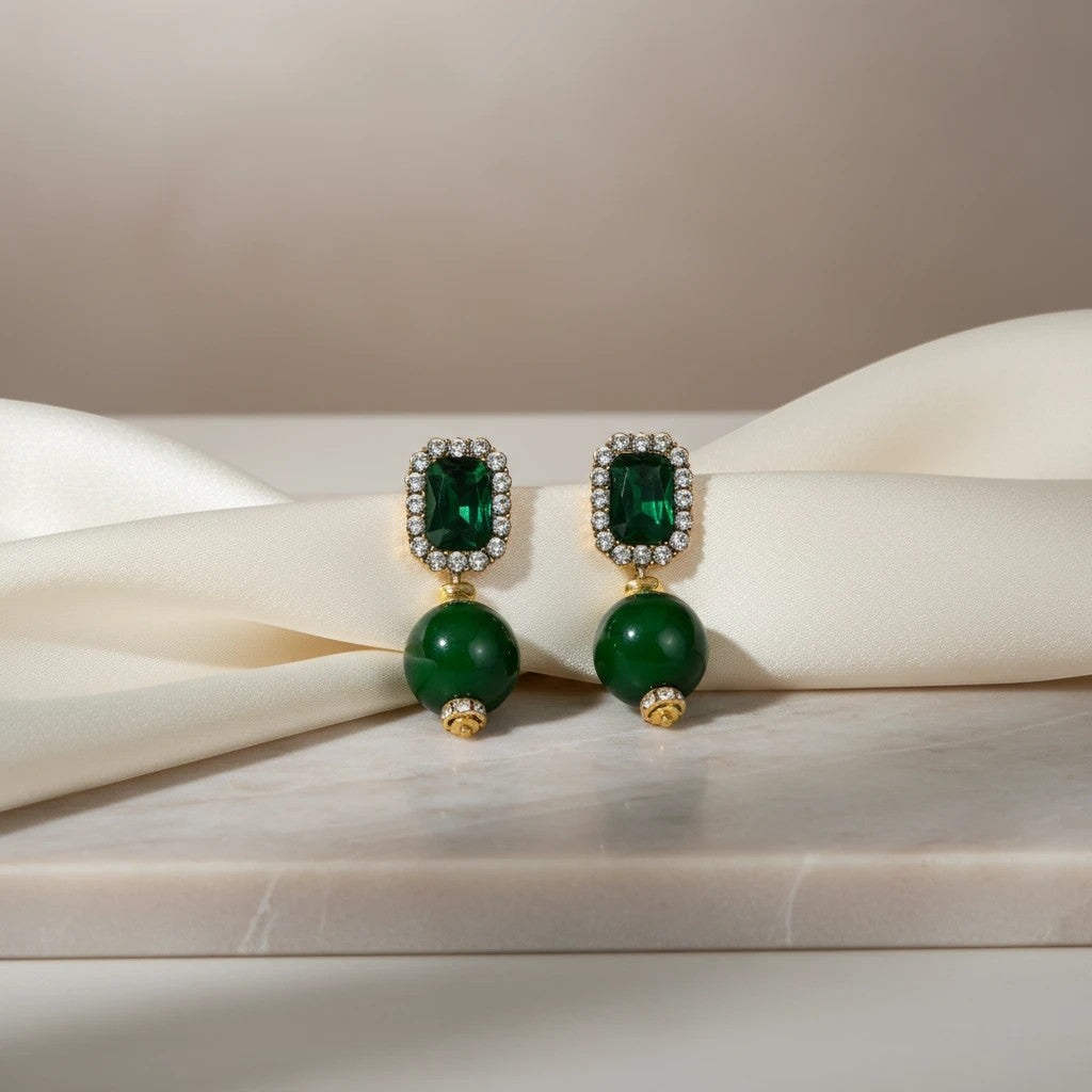 Elephantina.gr emerald cut gemstone drop earrings with crystal accents and green bead.