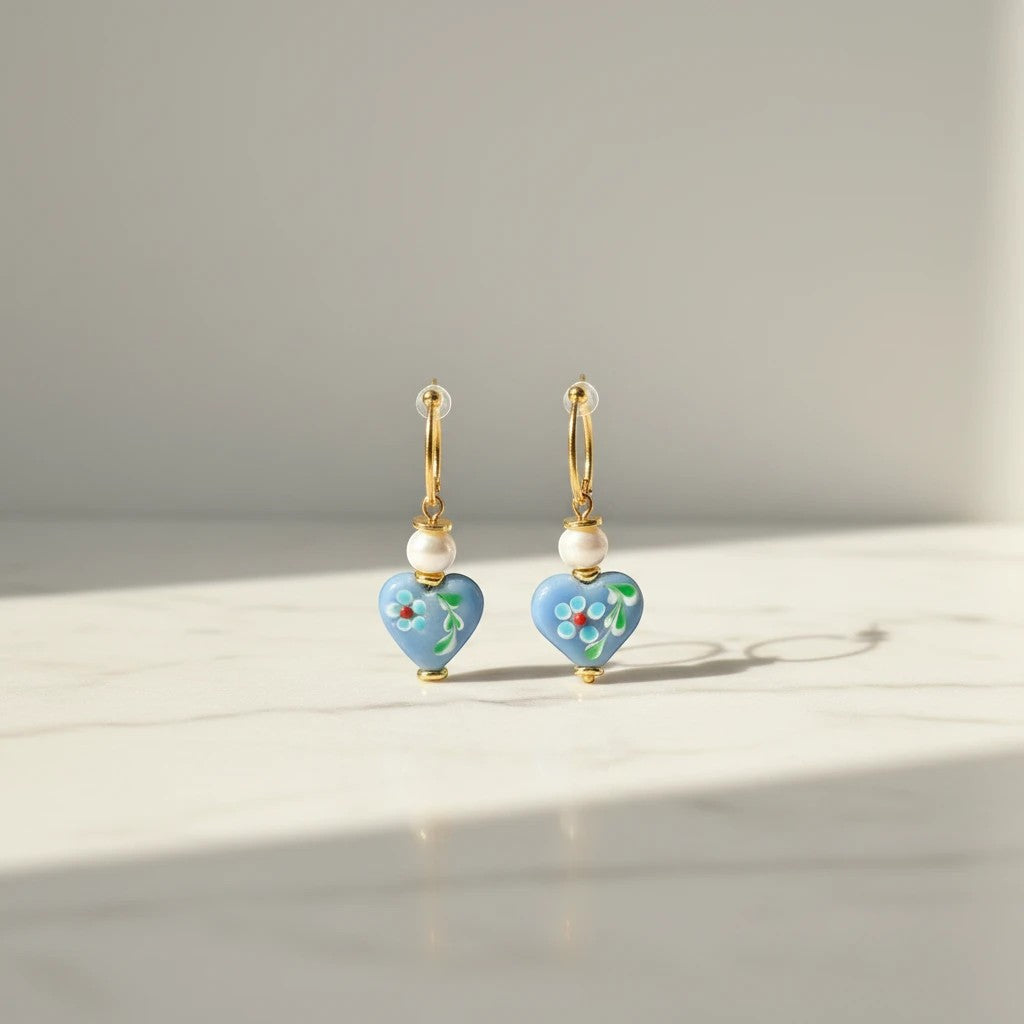 elephantina.gr gold hoop earrings with blue heart-shaped beads, white pearls, and hand-painted floral details.