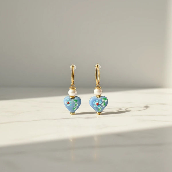 elephantina.gr gold hoop earrings with blue heart-shaped beads, white pearls, and hand-painted floral details.