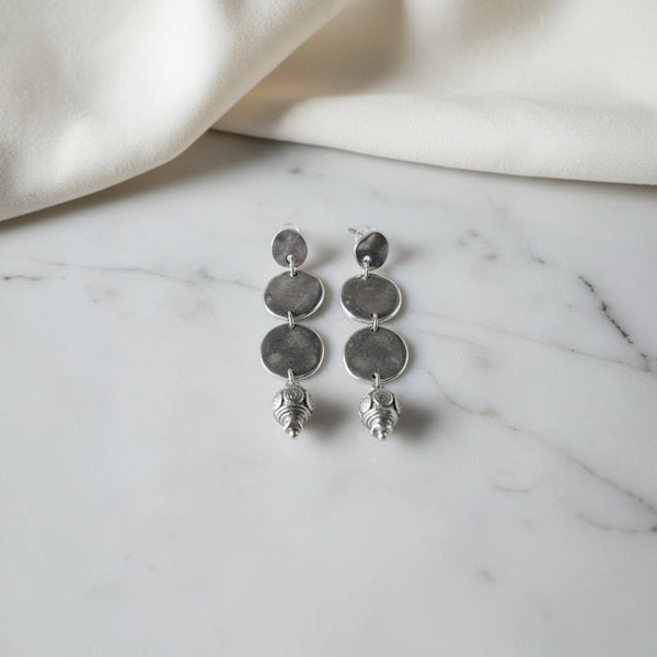 elephantina.gr silver-tone drop earrings with three hammered discs and a detailed bead charm.