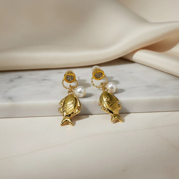 elephantina.gr gold-tone fish dangle earrings with faux pearls and glittery heart tops.