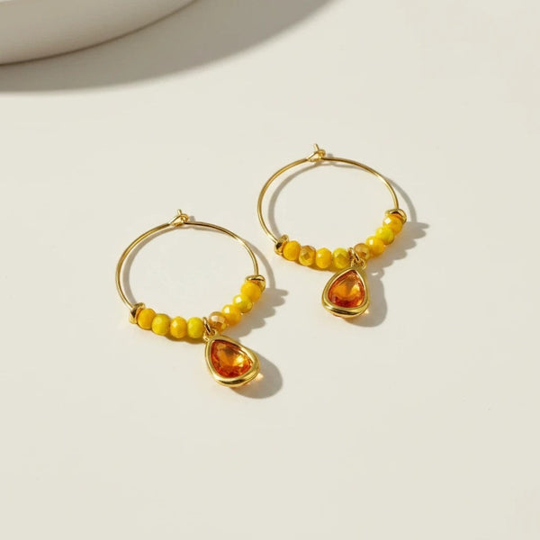 Elephantina.gr gold hoop earrings with yellow beads and orange teardrop crystal charms. Length 2.5 cm.